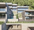 Multi-story apartment building with modern, minimalist design. The building features concrete and glass construction with balconies on each floor. There is a garage entrance visible on the ground level.