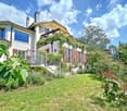 Detached house, white paint, large windows, balconies, covered entrance, garden