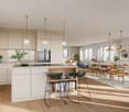 Spacious open-plan kitchen and dining area with modern, light-colored cabinetry, stainless steel appliances including a dishwasher, wooden countertops, and a large dining table with chairs. The room features large windows overlooking a scenic outdoor view