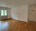 empty room, white walls, parquet flooring, sliding glass door to balcony, radiator