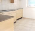 modern kitchen, tiled flooring, wooden cabinets, electrical outlets, stainless steel range hood, window with blinds