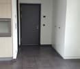 Entrance hall, kitchen cabinets, oven, tiled floor, closed door