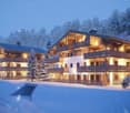 chalet-style building, illuminated balconies, snowy surroundings