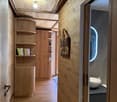 wooden walls, wooden floor, wooden shelves, books, wooden door, sink, toilet