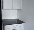 white cabinets, granite countertop, drawers, power outlet, tiled floor