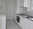 kitchen with integrated dishwasher, washing machine, oven, cabinets, white tiled floor, granite countertops