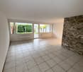 open room, sliding door, windows, tiled floor, stone wall, garden view