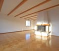empty room, fireplace in wall, wooden parquet floor, wooden ceiling beams
