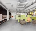 Open floor with seating area, kitchen and cabinets, industrial design with modern furnishings.
