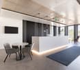 modern office space with white walls, gray flooring, a reception desk, a round table with chairs, a mounted TV, and large windows