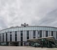 Modern office building with glass facade, circular entrance, and a rooftop sign reading 'Regus'.