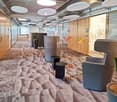 corridor, modern lamps, beige carpet, glass doors, potted plants, black chairs, orange lamps, wooden floors