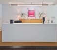 Modern desk, plants, artwork, wooden cabinet, metal stand, lights, desk items