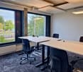conference room with 2 long desks and 4 chairs