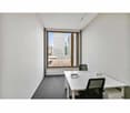 Minimalistic office room with large window and outside view, white desks and chairs