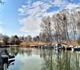 lake with boats, trees, sky, reflection