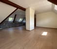 empty room, wooden floor, kitchen area, wooden beams