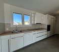 white cabinets, wooden countertops, stainless steel sink, electric stove, oven, large windows