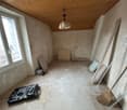 bare room, window, wooden ceiling, tools, broom, heater, unfurnished