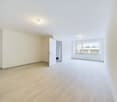 empty room, wooden floor, white walls, open door, bright window