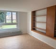 wooden floors, radiator, built-in shelves, double window, white walls