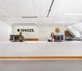 modern office, white walls, wooden desk, monitors, chairs, lamps, clock