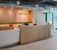 Reception desk, wooden walls, hanging lamps, large windows, minimalist decor