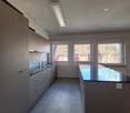 kitchen, no appliances, sink, large windows, tiled flooring, ceiling lights