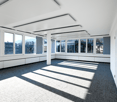 Empty room with white walls, gray carpet, large windows, central column, ceiling panels