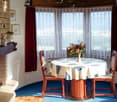 Fireplace, rug, dining table, chairs, view of outside