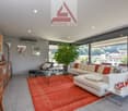 Two couches, large carpet, side table, glass coffee table, TV