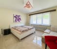 Double bed, nightstand, chest of drawers, picture frame, heater, couch, armchair, radiator