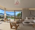 modern design, sliding glass doors to terrace, white couches, modern artwork, coffee table, view of mountains and buildings