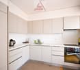 modern kitchen, white cabinets, countertop, sink, gas stove, oven, refrigerator