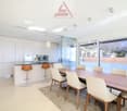modern kitchen with island, dining table, chairs, large windows, view of mountains
