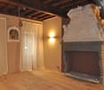 Fireplace, wooden floor, white curtains, picture frame