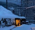 Stone house, covered with snow, open door, winter, snowy landscape