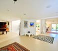 Modern design, wide open floor plan, piano, framed art, carpet, furniture, balcony