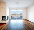 empty room, hardwood floor, fireplace, sliding glass doors, large window, balcony, scenic view
