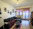 couch, coffee table, television, wall decorations, window