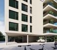 Modern multi-story residential building with underground parking, balconies, and cars parked in designated areas.