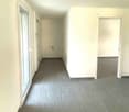 empty room, gray tile flooring, white walls, glass door, power outlets