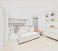 modern living room with white couch, white tiled floor, white cabinet, dining area, kitchen