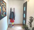 Painting, coat rack, clothes, statue, door, floor tiles