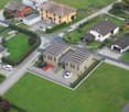 Modern residential complex with solar panels, multiple buildings, and parking areas.