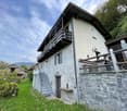 2 story house, stone wall, balcony, stairs, door, lamp
