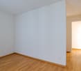empty room, wooden floor, white walls, doors leading to another room