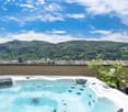 Outdoor area with Jacuzzi, plants, city skyline view