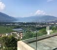 Glass wall balcony, paved terrace, mountain and lake view