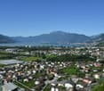 Aerial view of houses, mountains, lake, sky